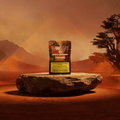 Verpackung von Red Lebanese Cannabis Hash von Green Passion auf einem Stein in einer Wüstenlandschaft.