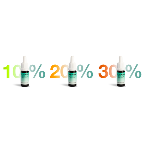 Three bottles of Dolocan CBD oil with labels indicating 10%, 20%, and 30% concentrations, arranged in a row.