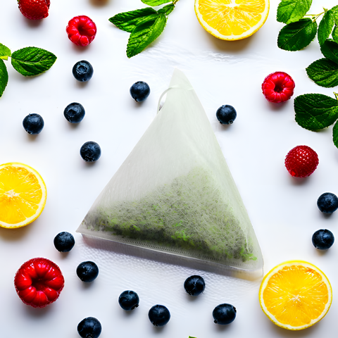 Bio-Hanftee-Pyramidenbeutel von Green Passion umgeben von Beeren und Zitronen. Frischer Geschmack mit natürlicher Wirkung.